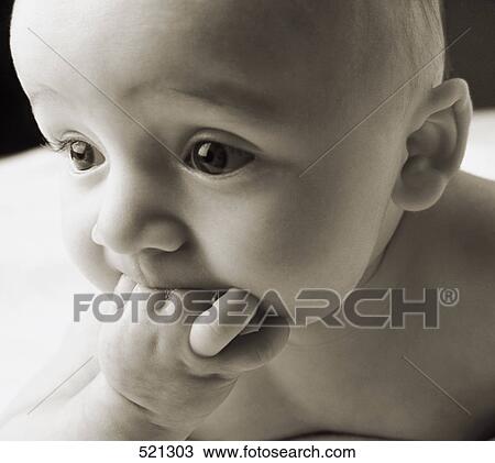 Stock Image - Baby sucking on its fingers. Fotosearch