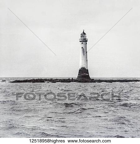 Stock Photograph - Bell Rock Lighthouse, off the coast of Angus, Scotland, is the world's oldest surviving sea-washed lighthouse. Magic lantern slide circa 1900; Angus, Scotland. Fotosearch