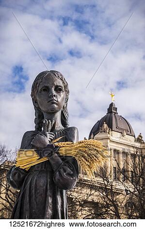 Stock Photograph - Bitter Memories of Childhood is a memorial statue on the Manitoba Legislative Grounds which pays tribute to the 1932-1933 Ukrainian Famine and Genocide under Soviet ruler Joseph Stalin. The Legislative Building and the Golden Boy are seen in the.... Fotosearch