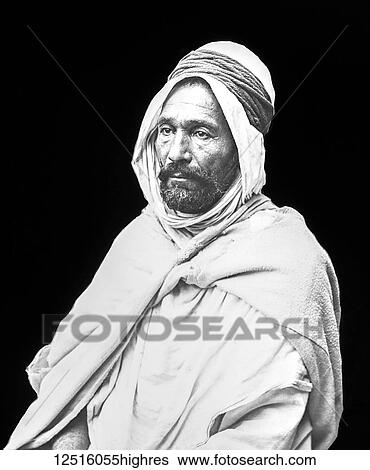 Stock Photograph - Black and white image of an Arab man against a black background; Algiers, Algeria. Fotosearch