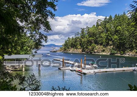 Stock Photograph - Boat Tours Run In And Out Of Butchart Cove, Vancouver Island; Victoria, British Columbia, Canada. Fotosearch