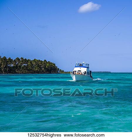 Stock Photograph - Boating in the turquoise waters of the Caribbean; Belize. Fotosearch