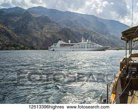 Stock Photograph - Boats and a cruise ship outside Kotor in the Bay of Kotor; Kotor, Kotor Municipality, Monte. Fotosearch