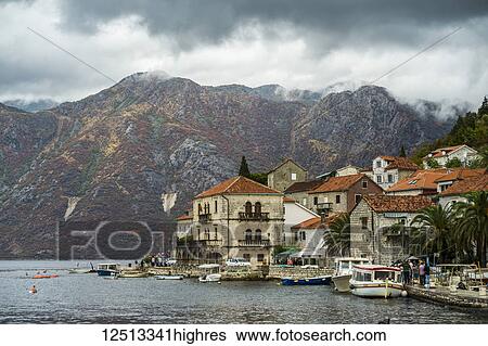 Stock Photograph - Boats and buildings in the town of Perast, along the coast of the Bay of Kotor; Perast, Kotor Municipality, Monte. Fotosearch
