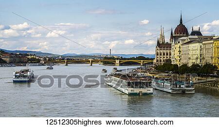 Stock Photograph - Boats and the waterfront of the Danube River and the Hungarian Parliament; Budapest, Budapest, Hungary. Fotosearch
