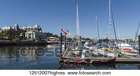 Stock Photograph - Boats docked in the tranquil Inner Harbour of Victoria, Vancouver Island; Victoria, British Columbia, Canada. Fotosearch