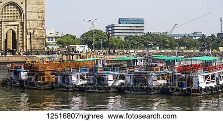 Boats mooring along the coast on the Arabian Sea at the Gateway of India; Mumbai, Maharashtra, India View Large Photo Image Stock Photograph - Boats mooring along the coast on the Arabian Sea at the Gateway of India; Mumbai, Maharashtra, India. Fotosearch