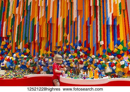 Stock Photograph - Boy building Lego tower in the Red Zone of the Lego House; Billund, Denmark. Fotosearch