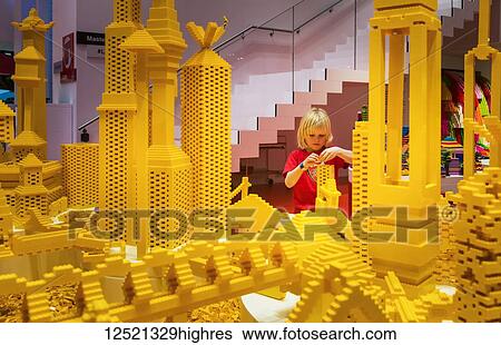 Stock Photograph - Boy building Lego tower in the Red Zone of the Lego House; Billund, Denmark. Fotosearch