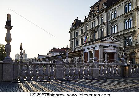 Stock Photograph - Bridge And Building At Sunrise, Old Town; Ljubljana, Slovenia. Fotosearch