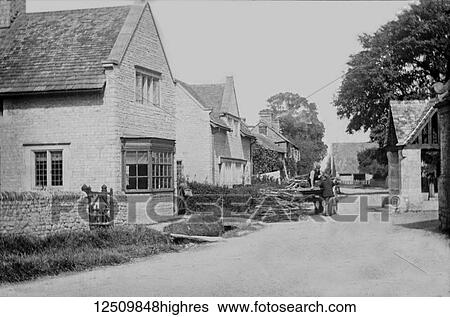 Stock Photograph - Buscot village, a little River Thames-side village depicted from a magic lantern slide circa 1900. Most of this tiny village is along a short cul-de-sac that leads from the ancient village hall to Buscot Lock on the River Thames; Buscot, Oxfordshire,.... Fotosearch
