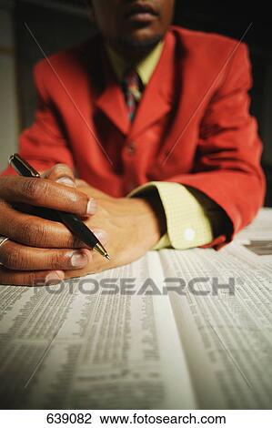 Businessman reading the journal View Large Photo Image Stock Image - Businessman reading the journal. Fotosearch