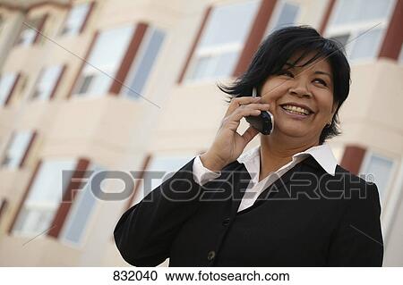 Stock Image - Businesswoman on cell phone. Fotosearch