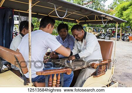 Cambodian men playing a board game onboard a tuk-tuk; Siem Reap, Cambodia View Large Photo Image Stock Photograph - Cambodian men playing a board game onboard a tuk-tuk; Siem Reap, Cambodia. Fotosearch