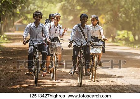 Stock Photograph - Cambodian school children on bicycles; Sambor Prei Kuk, Kompong Thom, Cambodia. Fotosearch