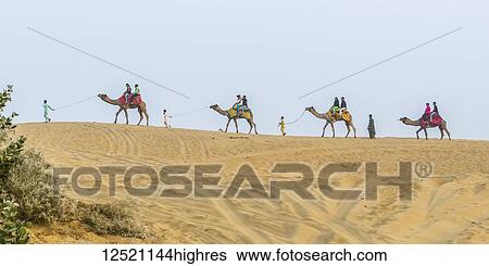 Stock Photograph - Camel safari on the Lakhmana Dunes, India. Fotosearch