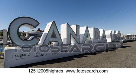 Stock Photograph - Canada 150 sign at the waterfront of the Inner Harbour of Victoria to celebrate 150 years of confederation, Vancouver Island; Victoria, British Columbia, Canada. Fotosearch