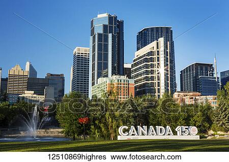 Canada 150 signage in city park with Calgary building towers in background with blue sky; Calgary, Alberta, Canada View Large Photo Image Stock Photograph - Canada 150 signage in city park with Calgary building towers in background with blue sky; Calgary, Alberta, Canada. Fotosearch