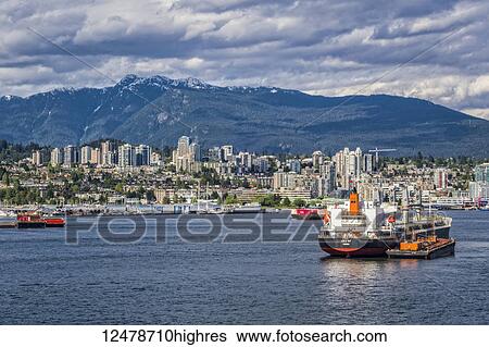 Stock Photograph - Cargo ships in the Vancouver harbour; Vancouver, British Columbia, Canada. Fotosearch