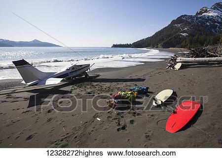 Stock Photograph - Cessna 206 Landed On The Outer Coast Of Kenai Peninsula Dropping Off Surfers And Gear, Southcentral Alaska, USA. Fotosearch