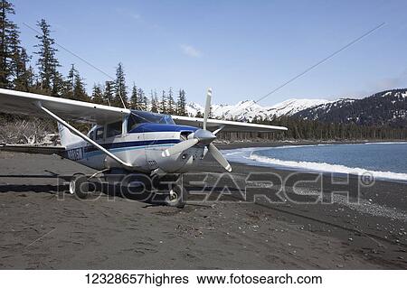 Cessna 206 parked on the beach at the water's edge along the Kenai Peninsula Outer Coast, South-central Alaska; Alaska, United States of America View Large Photo Image Stock Photograph - Cessna 206 parked on the beach at the water's edge along the Kenai Peninsula Outer Coast, South-central Alaska; Alaska, United States of America. Fotosearch