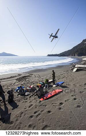 Stock Photograph - Cessna 206 Taking Off After Having Dropped Off Surfers And Gear, Kenai Peninsula Outer Coast, Southcentral Alaska, USA. Fotosearch