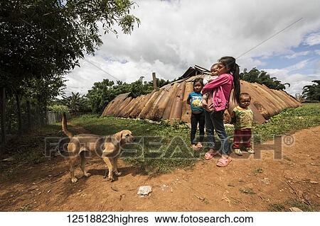 Children by a wall made from bomb casings, Na Kam Peng, also called Bomb Village; Xiangkhouang, Laos View Large Photo Image Stock Photograph - Children by a wall made from bomb casings, Na Kam Peng, also called Bomb Village; Xiangkhouang, Laos. Fotosearch