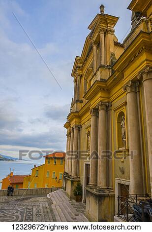 Stock Photograph - Church Building Facade And View Of The Mediterranean Sea; Menton, Cote D'azur, France. Fotosearch