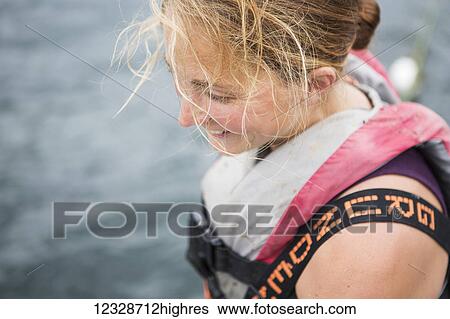 Stock Photograph - Close-up of a female set-net fisherman in her skiff near Seldovia, South-central Alaska; Alaska, United States of America. Fotosearch