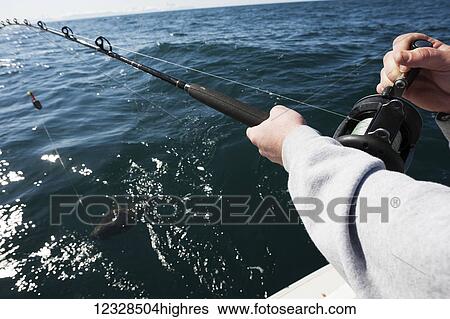 Close-up of a man holding a fishing rod with a halibut on the hook in Kachemak Bay, South-central Alaska; Homer, Alaska, United States of America View Large Photo Image Stock Photograph - Close-up of a man holding a fishing rod with a halibut on the hook in Kachemak Bay, South-central Alaska; Homer, Alaska, United States of America. Fotosearch