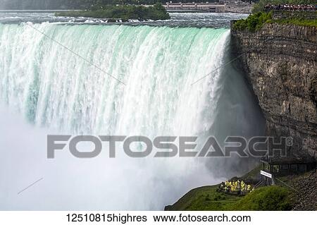 Close-up of Niagara Falls with cliffs and tourists standing on the viewing platforms; Niagara Falls, Ontario, Canada View Large Photo Image Stock Photograph - Close-up of Niagara Falls with cliffs and tourists standing on the viewing platforms; Niagara Falls, Ontario, Canada. Fotosearch