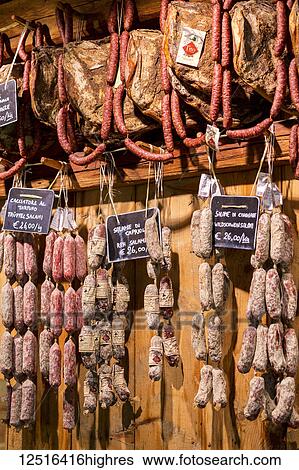 Stock Photograph - Close-up of sauages and meats hanging in deli; Sesto, Bolzano, Italy. Fotosearch