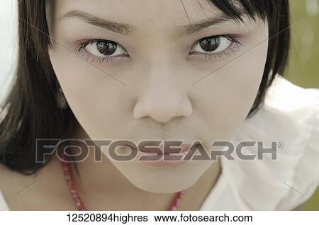 Close-up portrait of an Asian young woman's face; Mandalay, Myanmar View Large Photo Image Stock Photograph - Close-up portrait of an Asian young woman's face; Mandalay, Myanmar. Fotosearch