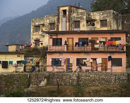 Stock Photograph - Clotheslines and doorways in a residential building, 0rthern India; Narendranagar, Uttarakhand, India. Fotosearch