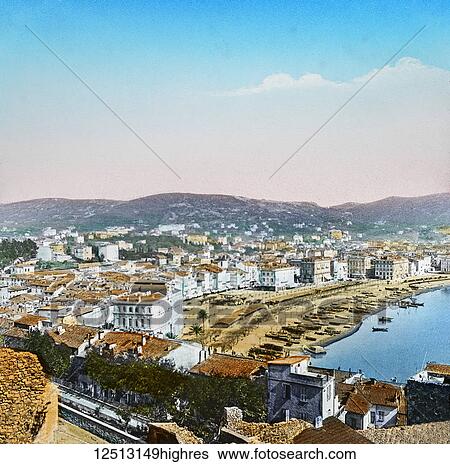 Coloured image of a Mediterranean town with boats in the tranquil water and hills in the distance View Large Photo Image Stock Photograph - Coloured image of a Mediterranean town with boats in the tranquil water and hills in the distance. Fotosearch