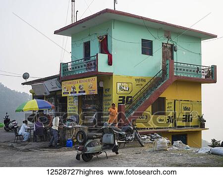 Stock Photograph - Colourful building of a restaurant and outdoor seating in the Himalayas, 0rthern India; Narendranagar, Uttarakhand, India. Fotosearch