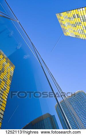 Stock Photograph - Colourful buildings and blue sky reflected in a glass building facade; Las Vegas, Nevada, United States of America. Fotosearch