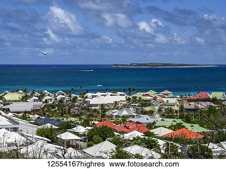 Stock Photograph - Colourful house rooftops looking out to sea on the island of St. Maarten; Philipsburg, Sint Maarten. Fotosearch