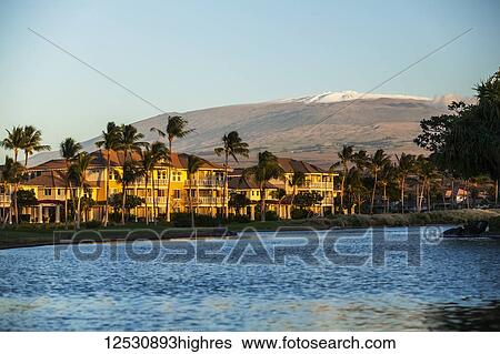 Condominiums and a view of the snow-capped Mauna Kea from the King's Shops at Waikoloa Resort; Island of Hawaii, Hawaii, United States of America View Large Photo Image Stock Photograph - Condominiums and a view of the snow-capped Mauna Kea from the King's Shops at Waikoloa Resort; Island of Hawaii, Hawaii, United States of America. Fotosearch