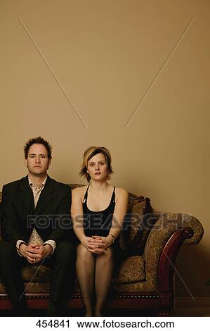 Stock Image - Couple sitting side by side. Fotosearch