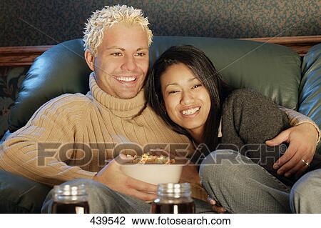 Stock Image - Couple watches a movie. Fotosearch