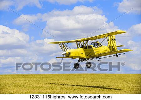 Stock Photograph - Crop Duster Spraying Herbicide On Fields Of Garbanzo Beans In The Palouse Region Of Eastern Washington; Washington, United States Of America. Fotosearch