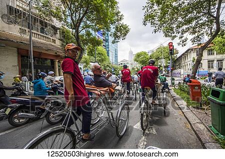 Cyclo tour in traffic; Ho Chi Minh City, Ho Chi Minh, Vietnam View Large Photo Image Stock Photograph - Cyclo tour in traffic; Ho Chi Minh City, Ho Chi Minh, Vietnam. Fotosearch