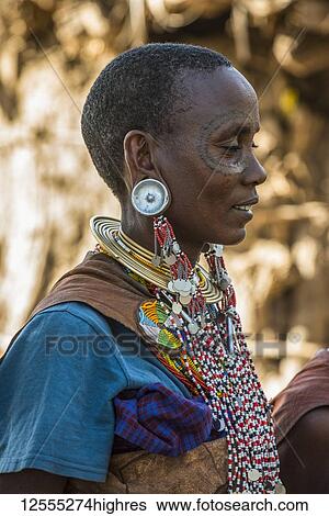 Stock Photograph - Datoga woman with facial tattoos wearing elaborate and colourful jewelry, near Lake Eyasi; Tanzania. Fotosearch