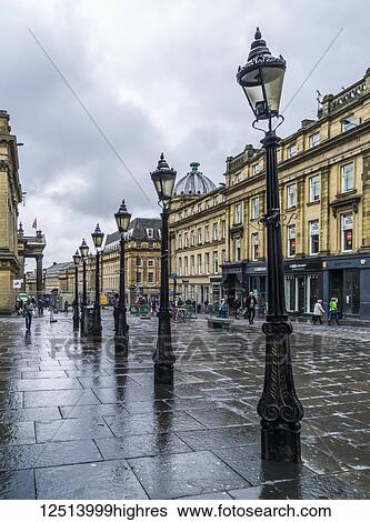 Decorative lamp posts in a row along a wet street with pedestrians and shops; Newcastle Upon Tyne, Tyne and Wear, England View Large Photo Image Stock Photograph - Decorative lamp posts in a row along a wet street with pedestrians and shops; Newcastle Upon Tyne, Tyne and Wear, England. Fotosearch