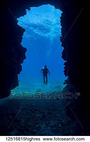 Stock Photograph - Diver at the entrance to First Cathedral off the island of Lanai; Hawaii, United States of America. Fotosearch