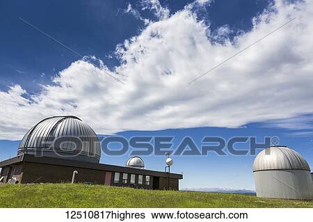 Domes of Astrophysical Observatory with dramatic clouds and blue sky, Southwest of Calgary; Alberta, Canada View Large Photo Image Stock Photograph - Domes of Astrophysical Observatory with dramatic clouds and blue sky, Southwest of Calgary; Alberta, Canada. Fotosearch