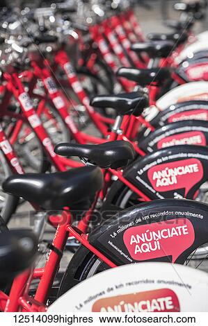 Electric battery powered city bicycles for hire, parked in a row; Bilbao, Vizcaya, Pais Vasco, Spain View Large Photo Image Stock Photograph - Electric battery powered city bicycles for hire, parked in a row; Bilbao, Vizcaya, Pais Vasco, Spain. Fotosearch