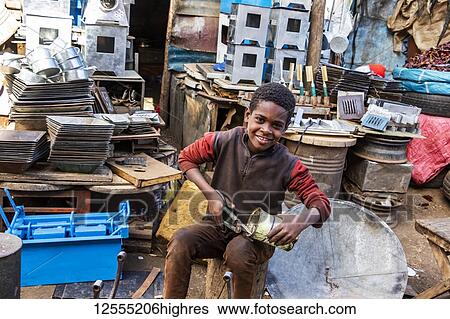 Eritrean boy cutting a can at the Medeber Market, where artisans recycle old tyres and tins to make new artifacts; Asmara, Central Region, Eritrea View Large Photo Image Stock Photograph - Eritrean boy cutting a can at the Medeber Market, where artisans recycle old tyres and tins to make new artifacts; Asmara, Central Region, Eritrea. Fotosearch