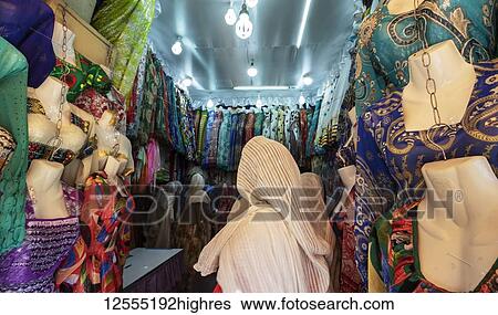 Eritrean woman at a clothing shop in the Mercato of the indigenous people; Asmara, Central Region, Eritrea View Large Photo Image Stock Photograph - Eritrean woman at a clothing shop in the Mercato of the indigenous people; Asmara, Central Region, Eritrea. Fotosearch
